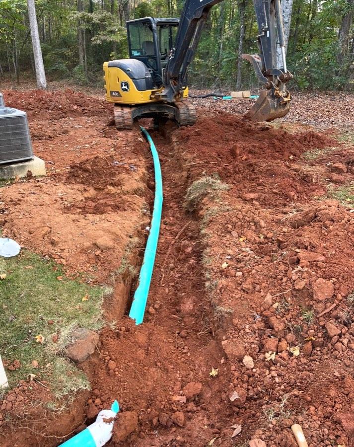 Excavator supporting a utility install
